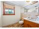 Bathroom featuring wood vanity and a large mirror at 700 Stewart Rd, Covington, GA 30016