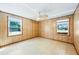 Charming bedroom with wood paneling and natural light at 700 Stewart Rd, Covington, GA 30016
