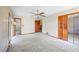 Bedroom featuring a ceiling fan, mirrored closet, and doorways to other rooms at 700 Stewart Rd, Covington, GA 30016