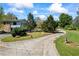 Long driveway leads to a charming two-story home with stone accents and a yard at 700 Stewart Rd, Covington, GA 30016