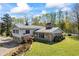 Charming home featuring stone accents, a metal roof, and a lush green lawn at 700 Stewart Rd, Covington, GA 30016