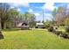 Expansive front yard featuring a quaint stone outbuilding and a barn at 700 Stewart Rd, Covington, GA 30016
