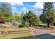 Manicured lawns, stone retaining walls, walkways, trees, and bushes give the home great curb appeal at 700 Stewart Rd, Covington, GA 30016