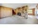 Spacious living room with wood paneling and stone fireplace at 700 Stewart Rd, Covington, GA 30016