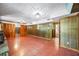 Finished basement area with wood paneled walls, retro flooring and access to other parts of the home at 700 Stewart Rd, Covington, GA 30016