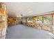 Bright enclosed porch with stone walls and bright windows overlooking well manicured landscaping at 700 Stewart Rd, Covington, GA 30016