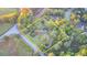 Bird's eye view shows mature trees surrounding the property outlined in yellow at 21 W Lake Dr, Oxford, GA 30054