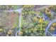 Aerial shot of the property shows a lot bordered in yellow with mature trees in a wooded area at 21 W Lake Dr, Oxford, GA 30054