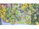 Overhead view features lush, mature trees surrounding a property outlined in yellow at 21 W Lake Dr, Oxford, GA 30054