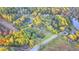 Beautiful aerial view of the property, outlined in yellow, surrounded by mature trees and with lake access at 21 W Lake Dr, Oxford, GA 30054