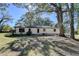 Backyard with trees, grass and back of house at 21 W Lake Dr, Oxford, GA 30054