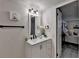 Well-lit bathroom featuring a modern vanity, neutral walls, and an open doorway into a bedroom at 21 W Lake Dr, Oxford, GA 30054