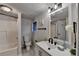 Well-lit bathroom featuring a shower-tub, toilet, neutral walls, and a modern vanity at 21 W Lake Dr, Oxford, GA 30054