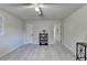 Light, airy bedroom with a ceiling fan and light, light walls, and an opening into a hallway at 21 W Lake Dr, Oxford, GA 30054