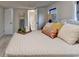 Cozy bedroom featuring a decorative ladder, plush bedding, and access to a connected bathroom at 21 W Lake Dr, Oxford, GA 30054