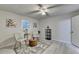 A calm, neutral bedroom with decor, soft lighting, and views through two adjacent windows at 21 W Lake Dr, Oxford, GA 30054