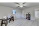 Home office area featuring modern decor, light gray walls, and a ceiling fan with light at 21 W Lake Dr, Oxford, GA 30054