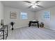 Bright bedroom featuring modern decor, light gray walls, and a ceiling fan with light at 21 W Lake Dr, Oxford, GA 30054
