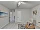 Light, airy bedroom with a ceiling fan and light, light walls, and a glimpse into the hallway at 21 W Lake Dr, Oxford, GA 30054