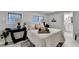 Bright bedroom featuring a large bed with decorative pillows and an adjacent bathroom at 21 W Lake Dr, Oxford, GA 30054