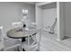 Dining room with a round table, chairs, a door leading outside, and laundry hookups at 21 W Lake Dr, Oxford, GA 30054