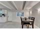Bright dining room with gray wood flooring, sleek white walls, and white ceiling beams at 21 W Lake Dr, Oxford, GA 30054