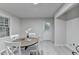 Bright dining room featuring a round table, white chairs, and modern, stylish decor at 21 W Lake Dr, Oxford, GA 30054