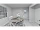Bright dining room featuring a round table, white chairs, and modern, stylish decor at 21 W Lake Dr, Oxford, GA 30054