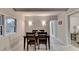 Dining room boasts hardwood floors, overhead lighting, and furniture with view to living room at 21 W Lake Dr, Oxford, GA 30054
