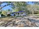 Exterior view of a single-story home with a covered porch and spacious yard, surrounded by trees at 21 W Lake Dr, Oxford, GA 30054