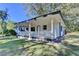 Quaint single-story home featuring a charming front porch, perfect for enjoying the outdoors at 21 W Lake Dr, Oxford, GA 30054