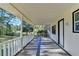 Inviting covered front porch with a wooden deck, offering a relaxing outdoor space at 21 W Lake Dr, Oxford, GA 30054