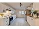 Bright kitchen features stainless steel appliances, quartz countertops and black hardware on white cabinets at 21 W Lake Dr, Oxford, GA 30054