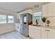 Modern kitchen features white cabinetry, stainless steel refrigerator, quartz countertops, and stainless steel sink at 21 W Lake Dr, Oxford, GA 30054