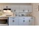 Well-lit kitchen showcases ample white cabinets, stainless steel stove, and sleek quartz countertops at 21 W Lake Dr, Oxford, GA 30054
