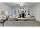Bright living room featuring a fireplace, large windows, and comfortable seating, perfect for Gathering time at 21 W Lake Dr, Oxford, GA 30054