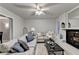 Inviting living room with a gray sectional sofa, fireplace, and neutral decor, perfect for relaxing at 21 W Lake Dr, Oxford, GA 30054