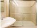 Close up on a bathtub with glass doors and a pedestal sink at 2285 Peachtree Ne Rd # 604, Atlanta, GA 30309