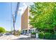 Exterior view of the high-rise condominium building with lush landscaping and street access at 2285 Peachtree Ne Rd # 604, Atlanta, GA 30309