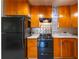 Kitchen featuring black appliances, light countertops, tile backsplash, and wooden cabinets at 2285 Peachtree Ne Rd # 604, Atlanta, GA 30309