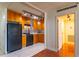Well-lit kitchen featuring light-colored tile flooring, wooden cabinets, and modern, black appliances at 2285 Peachtree Ne Rd # 604, Atlanta, GA 30309