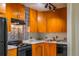 Kitchen showcases wooden cabinets, black appliances, tile backsplash, and modern countertops at 2285 Peachtree Ne Rd # 604, Atlanta, GA 30309