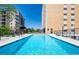 Exterior shot of a clear blue pool and lounge seating near the building at 2285 Peachtree Ne Rd # 604, Atlanta, GA 30309