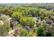 An aerial shot of a house in a neighborhood surrounded by green trees at 482 Cooper Lake Se Rd, Smyrna, GA 30126