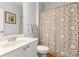 Bathroom features a neutral color scheme, single sink, decorative shower curtain, and white cabinets at 482 Cooper Lake Se Rd, Smyrna, GA 30126
