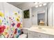 Bright bathroom with floral shower curtain, ample vanity space, and neutral decor at 482 Cooper Lake Se Rd, Smyrna, GA 30126