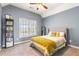Cozy bedroom with a plush bed, a view to the outside, and a bookcase with storage at 482 Cooper Lake Se Rd, Smyrna, GA 30126