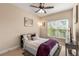 Cozy bedroom has neutral color scheme, ceiling fan, and a large window at 482 Cooper Lake Se Rd, Smyrna, GA 30126