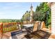 A wooden deck features an outdoor table with seating and an umbrella, with a scenic view beyond at 482 Cooper Lake Se Rd, Smyrna, GA 30126