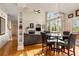 Cozy dining area adjacent to the living room featuring large windows and a modern light fixture at 482 Cooper Lake Se Rd, Smyrna, GA 30126